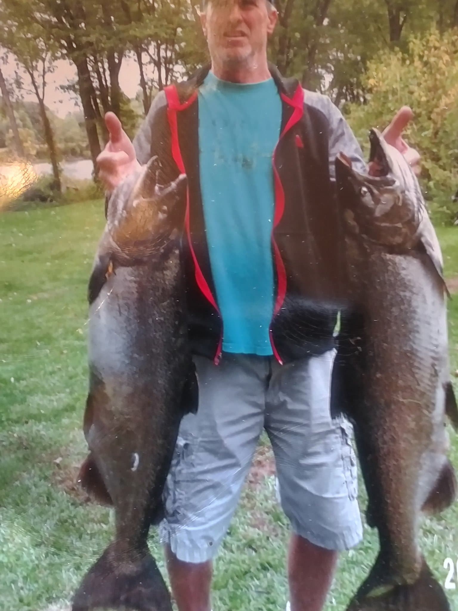 Captain Ken Clark holding a large catfish